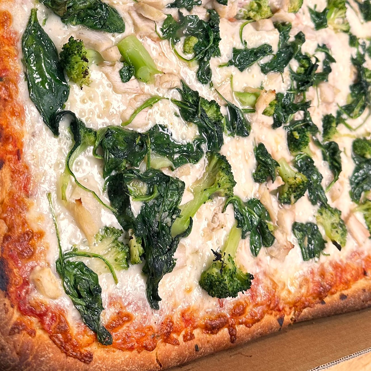 Broccoli or Spinach White Specialty Pizza.